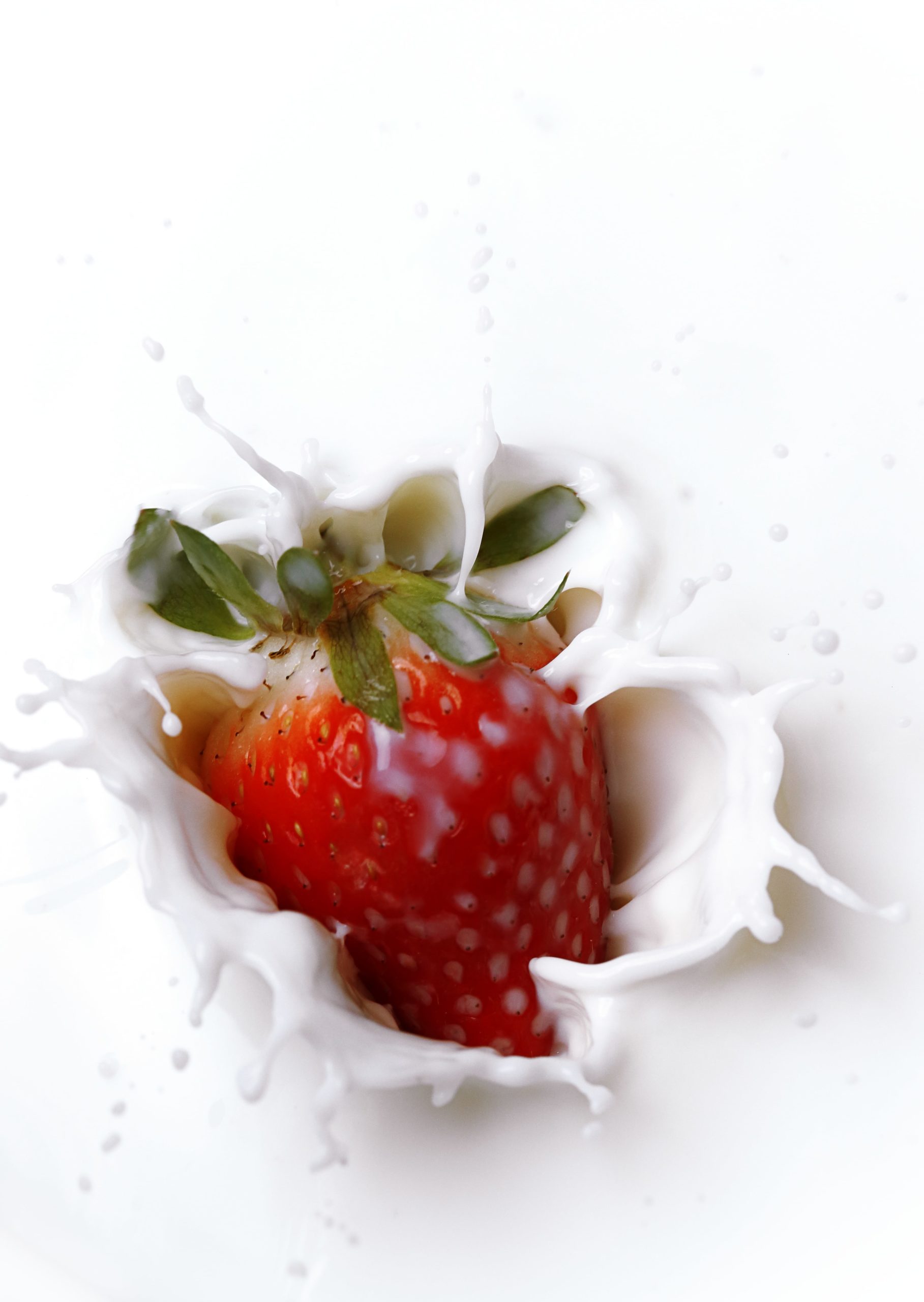 Strawberry splashing in milk
